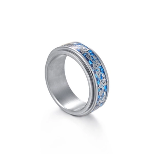 Macro detail of 8mm men's spinner ring featuring blue carbon fiber and dragon pattern