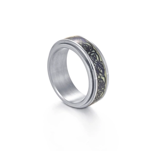 Macro detail of 8mm rotatable titanium steel ring with luminous Celtic knot pattern