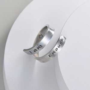 Detailed view of silver spiral open ring with I am Enough engraved lettering