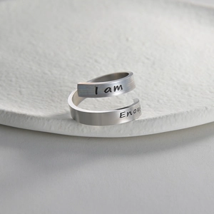 Detailed view of spiral stainless steel ring engraved with I am Enough quote
