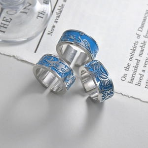 Three men's open rings featuring shark and owl motifs with blue enamel details