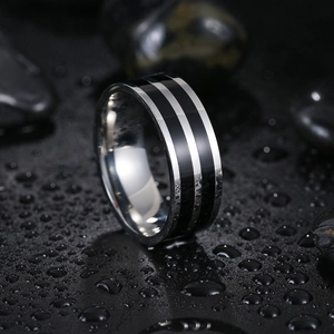 8mm double black groove stainless steel ring for men on wet black stones background