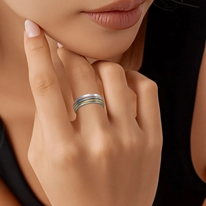 Close-up of three-tone spinning titanium steel rings in silver, gold, and rose gold finish