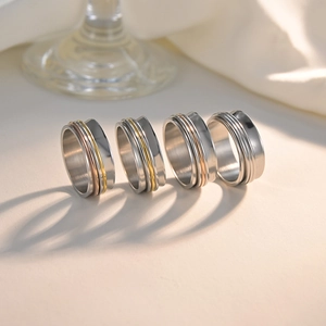 Set of four 8mm rotatable stainless steel spinner rings in silver, gold, and rose gold finishes