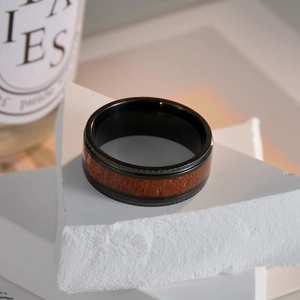 Men's black titanium steel ring with natural walnut wood inlay and polished beveled edges