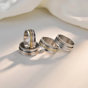 Three-color 8mm stainless steel spinner rings in silver, gold, and rose gold finishes