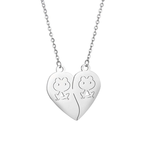 Macro detail of interlocking heart pendants with frog cutouts on stainless steel necklaces