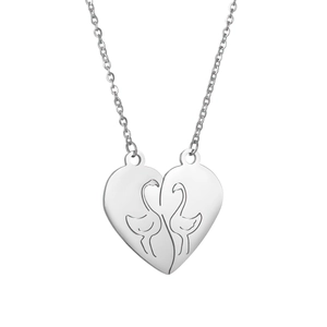 Detail of silver couple necklaces with flamingo engraved heart puzzle pendants