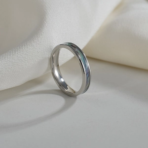 Polished 4mm titanium steel ring with iridescent abalone shell inlay on white silk