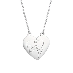 Detail of interlocking heart pendants with cut-out kissing couple silhouettes on silver chains