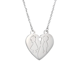 Detailed view of silver heart pendant featuring split boy and girl silhouette engraving