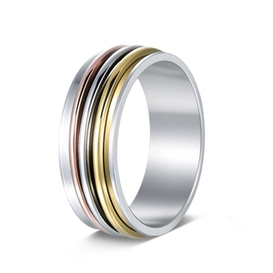 Detailed view of three-tone stainless steel spinner ring with rotating gold and silver bands