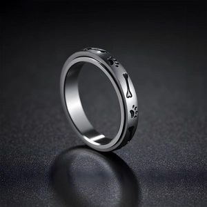 Polished silver spinner ring for stress relief with black dog paw and bone engraving
