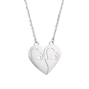 Detailed macro view of two interlocking heart pendants in polished silver stainless steel