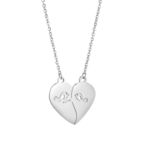 Macro detail of the bird silhouette cutout on a polished heart-shaped split pendant