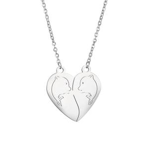Close-up of split heart pendant necklaces with engraved dolphins in silver finish