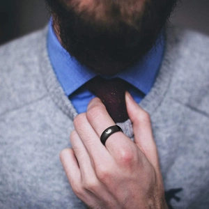 Black 8mm stainless steel ring with white Yin-Yang laser pattern worn by a male model