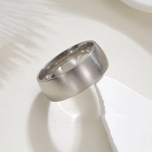 8mm brushed stainless steel ring for men displayed on a white textured background