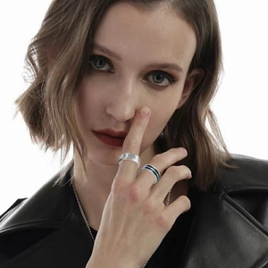 Five-piece silver stainless steel ring set shown on model in black leather jacket