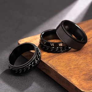 Detail view of 8mm black titanium spinning rings with chain and Roman numeral engraving