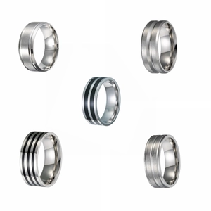 Detailed view of five silver stainless steel rings with brushed and polished finishes