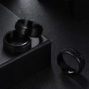 Three-piece black titanium steel spinner ring set with chain and geometric patterns