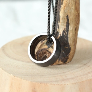 Pendentif anneau en tungstène noir avec chaîne box sur présentoir en bois