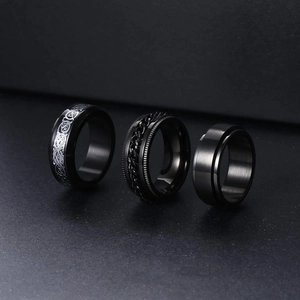 Three-piece black titanium steel spinner rings set featuring dragon and chain motifs