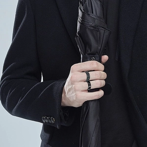 Men's titanium steel black ring set with matte and polished finishes on hands