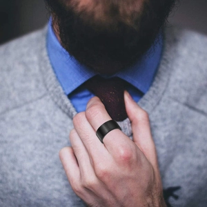 Minimalist 10mm matte black punk titanium steel ring for men in a casual lifestyle setting