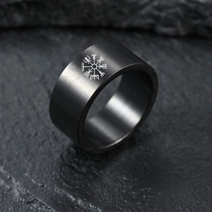 Black brushed titanium steel ring with white Viking Vegvisir compass symbol on stone surface