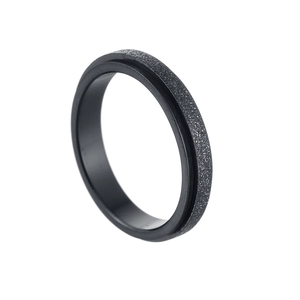 Detailed macro view of 4mm black sandblasted titanium steel spinning anxiety ring