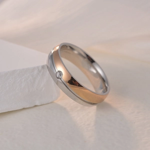 Two-tone 6mm stainless steel couple ring with silver and rose gold plating and a round diamond