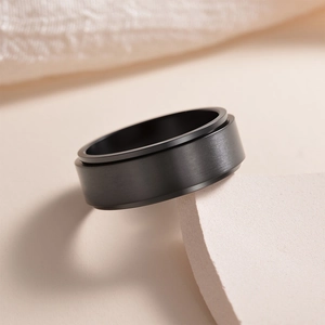 Minimalist 8mm matte black spinning anxiety ring in brushed stainless steel for men