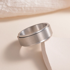 Detail view of 8mm matte brushed titanium steel spinning ring for anxiety relief