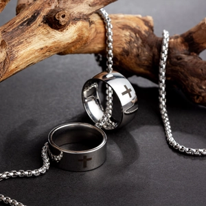 Polished cross engraved ring set with round box chain on aesthetic wooden display