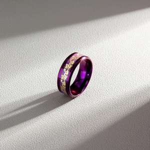 Macro view of purple stainless steel ring with detailed golden dragon engraving pattern