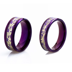 Macro detail of purple titanium rings featuring intricate golden dragon pattern engravings