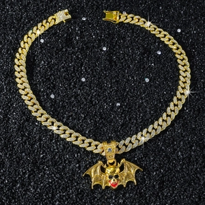 Close-up of hip hop bat skull pendant with red teeth detail and sparkling crystals