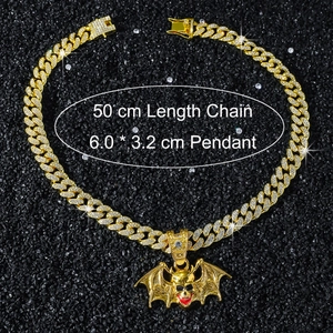Detail view of iced out bat skull pendant with dimensions 6.0 x 3.2 cm on golden chain