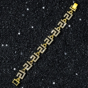 Macro view of gold 14mm hip hop chain bracelet with iced out Greca geometric links