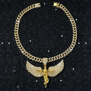 Macro shot of gold-plated iced-out angel pendant on heavy Cuban link chain jewelry