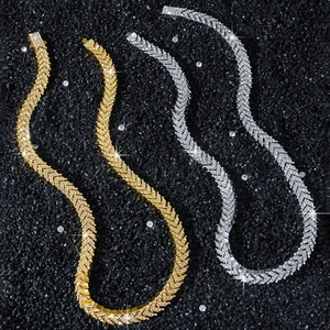 Men's hip hop gold and silver iced out V-shaped link necklace on black stone background
