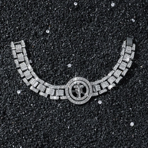 Men's hip hop silver chain bracelet with rotating iced out cross on black stone background