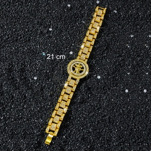 Close-up of hip hop gold cross bracelet with white rhinestones and 21cm length detail