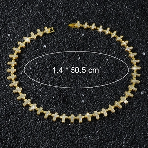 Detailed view of golden hip hop chain with iced out cross links measuring 1.4 by 50.5 cm