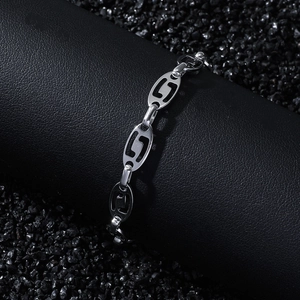 Vintage stainless steel oval link chain bracelet with cutout patterns on black display