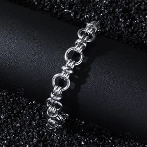 Modern industrial stainless steel chain bracelet with interlocking circular links on dark background