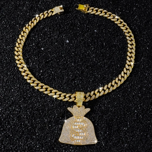 Détail du pendentif sac d'argent doré serti de diamants sur une chaîne cubaine homme