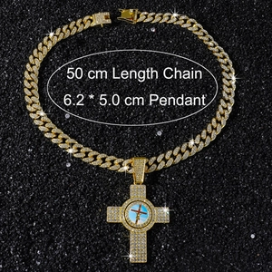 Close-up of iced out gold plated Cuban chain and cross pendant with Jesus motif